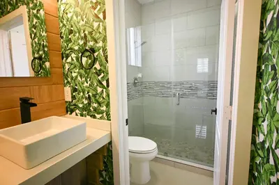 a bathroom with a sink and a toilet at LuxOasis Getaway Minigolf, Pool, Beach, Chess, Jacuzzi in Tamiami
