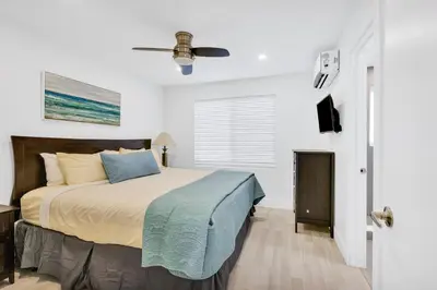 a bedroom with a bed and a ceiling fan at ULTRA Modern Apartment by the Beach in Hollywood