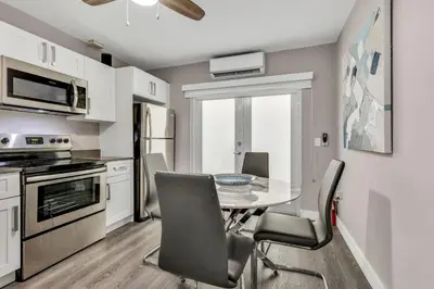 a kitchen with a dining room table and chairs at ULTRA magical apartment at the Beach in Hollywood