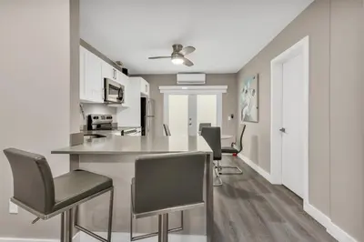 a kitchen with a counter and chairs in a room at ULTRA magical apartment at the Beach in Hollywood