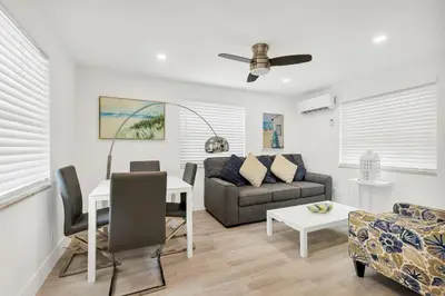 a living room with a couch and a table at ULTRA spacious apartment steps from the beach in Hollywood