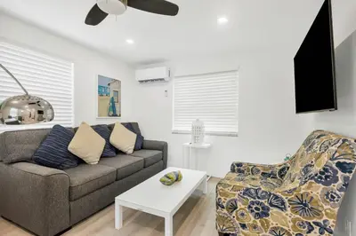 a living room with a couch and a chair at ULTRA spacious apartment steps from the beach in Hollywood