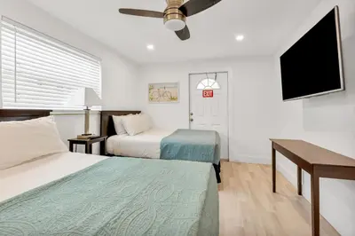 a hotel room with two beds and a flat screen tv at ULTRA joyful apartment perfect for families in Hollywood