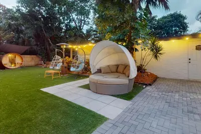 a couch in a yard with a playground at Entertainer's Paradise in Fort Lauderdale