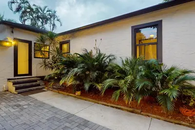 a house with palm trees in front of it at Entertainer's Paradise in Fort Lauderdale