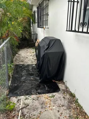 a dog standing next to a building with a black umbrella at LaBella Suite in Miami