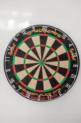 a dartboard is sitting on top of a table at Ventur Tropical with Elite Pool & Ultimate Fun Zone in Fort Lauderdale