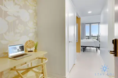 a room with a desk and a laptop on a table at Amazing Studio Infinity View Balcony in Hallandale Beach
