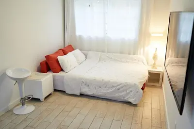 a small bedroom with a bed and a window at Private Villa Miami Pool Oasis in Miami