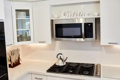 a kitchen with a stove and a microwave at Private Villa Miami Pool Oasis in Miami