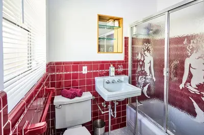 a red tiled bathroom with a sink and a toilet at Private Villa Miami Pool Oasis in Miami