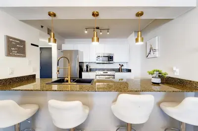 a kitchen with white countertops and gold appliances at 2 bed condo, Queen sofa bed Brickell, Free Parking, Pool, Gym in Miami