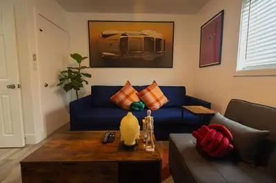 a living room with a blue couch and a coffee table at The Myrlande Dinvil Guest Suite in North Miami Beach