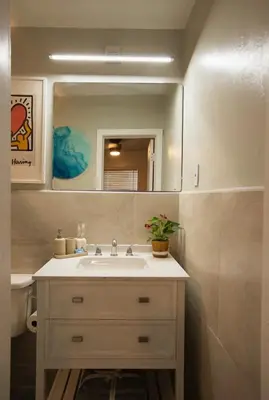 a bathroom with a sink and a mirror at The Myrlande Dinvil Guest Suite in North Miami Beach
