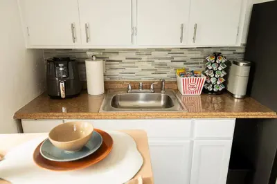 a kitchen counter with a sink and a bowl on a plate at The Myrlande Dinvil Guest Suite in North Miami Beach