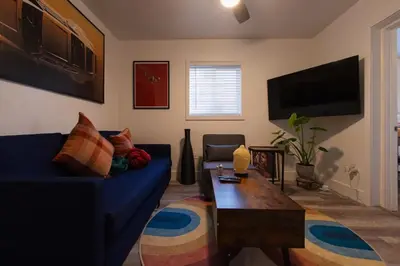 a living room with a blue couch and a coffee table at The Myrlande Dinvil Guest Suite in North Miami Beach