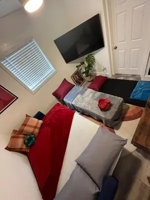 a bedroom with two beds and a flat screen tv at The Myrlande Dinvil Guest Suite in North Miami Beach