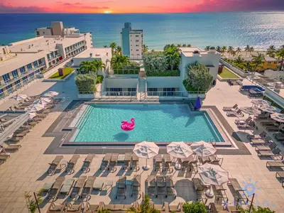 an overhead view of a pool with chairs and umbrellas at Rooftop Pool Balcony Hollywood Beach Broad walk in Hollywood