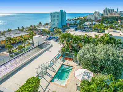 an aerial view of a resort with a swimming pool and the beach at Rooftop Pool Balcony Hollywood Beach Broad walk in Hollywood