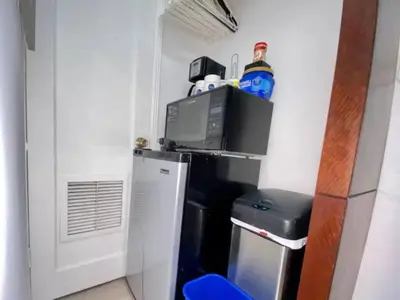 a small kitchen with a refrigerator and a microwave at Private guest house in the heart of Miami! Surrounded by Miami's HOT spots! in Miami
