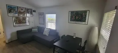 a living room with a blue couch and a table at Private guest house in the heart of Miami! Surrounded by Miami's HOT spots! in Miami