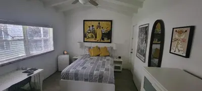 a bedroom with a bed with yellow pillows at Private guest house in the heart of Miami! Surrounded by Miami's HOT spots! in Miami