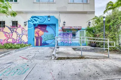 a building with graffiti on the side of it at Wynwood Condo, Walk to Restaurants and Nightclubs! in Miami