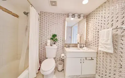 a bathroom with a toilet and a sink and a tub at Serene View 1 BR in Miami