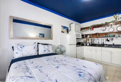 a bedroom with a bed with a blue ceiling at The Plaza Miami Beach in Miami Beach