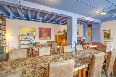 a dining room with a large table and chairs at The Plaza Miami Beach in Miami Beach