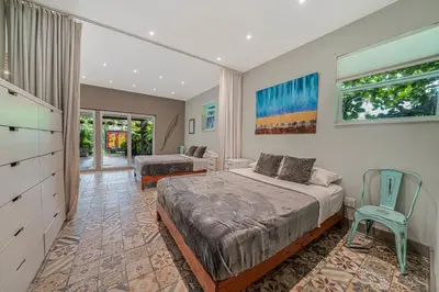 a bedroom with a bed and a desk and a chair at New Villa Jungle Paradise Heated Pool BBQ Soccer in Miami