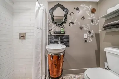 a bathroom with a sink and a mirror at New Villa Jungle Paradise Heated Pool BBQ Soccer in Miami