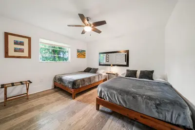 a bedroom with two beds and a ceiling fan at New Villa Jungle Paradise Heated Pool BBQ Soccer in Miami