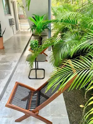 a bench in a courtyard with some plants at GroveO6 10 minutes from the Beach in Miami