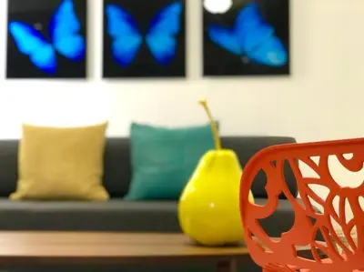 a living room with a couch with blue butterflies at GroveO6 10 minutes from the Beach in Miami