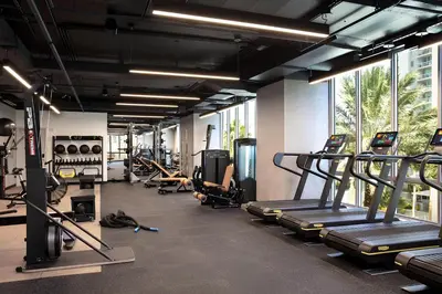 a gym with treadmills and machines in a room at NEW Luxury Downtown Apartment - Gym Pool Workspace in Miami
