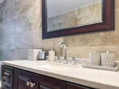a bathroom counter with a sink and a mirror at Ocean Drive apartment w Balcony Walk to the Beach in Miami Beach