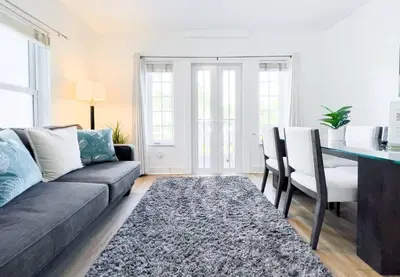a living room with a couch and a table at Ocean Drive apartment w Balcony Walk to the Beach in Miami Beach