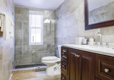 a bathroom with a shower and a toilet and a sink at Ocean Drive apartment w Balcony Walk to the Beach in Miami Beach