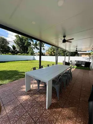 a white table with chairs and a ceiling fan at Villa Bethesda in Miami