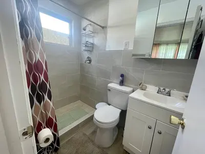 a bathroom with a toilet and a sink at Bright & Cozy Family Home Near Dania Beach in Dania Beach