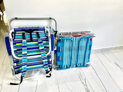 a towel rack with blue and white striped towels at Bright & Cozy Family Home Near Dania Beach in Dania Beach