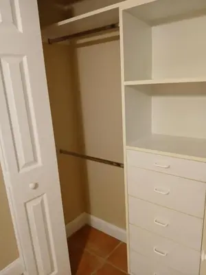 a closet with white cabinets and a door at Beautiful Miami Home in Miami
