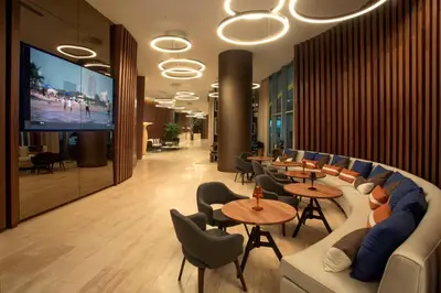 a lobby with tables and chairs and a flat screen tv at Oceanfront Luxury Condo With WaterView in Hollywood