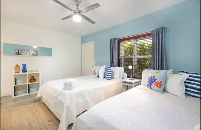a bedroom with two beds and a ceiling fan at B02 5 min from beach studio Midtown Wynwood in Miami