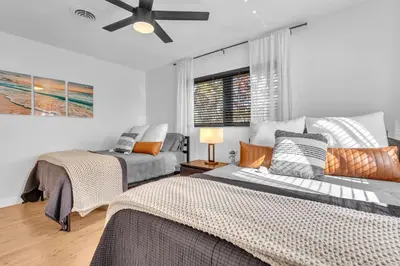 a bedroom with two beds and a ceiling fan at Family Beach Home With Home Theater & Heated Pool! in Hollywood