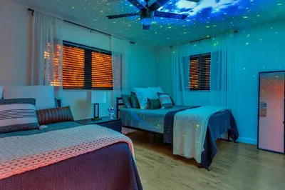 a bedroom with two beds and a ceiling fan at Family Beach Home With Home Theater & Heated Pool! in Hollywood