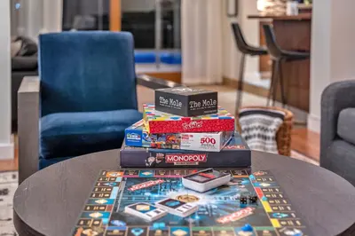 a pile of books sitting on top of a table at Family Beach Home With Home Theater & Heated Pool! in Hollywood