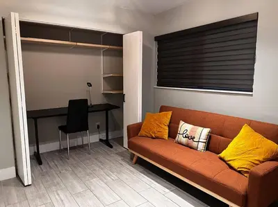 a living room with a couch and a desk at Luxurious Westchester Home Near Miami Clinics in Miami
