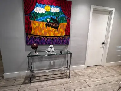 a glass table in a room with a painting on the wall at Luxurious Westchester Home Near Miami Clinics in Miami
